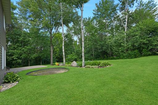 Stunning perennial gardens and a variety of mature trees for year-round interest