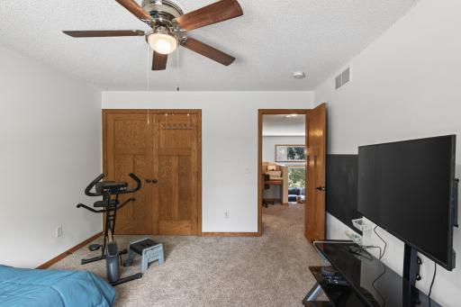Upper level bedroom and view to closet and hallway