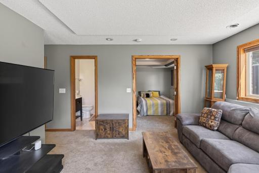 Lower level family room with view to bathroom and bedroom