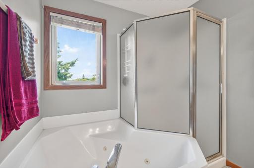 Shower and jetted tub in primary bathroom