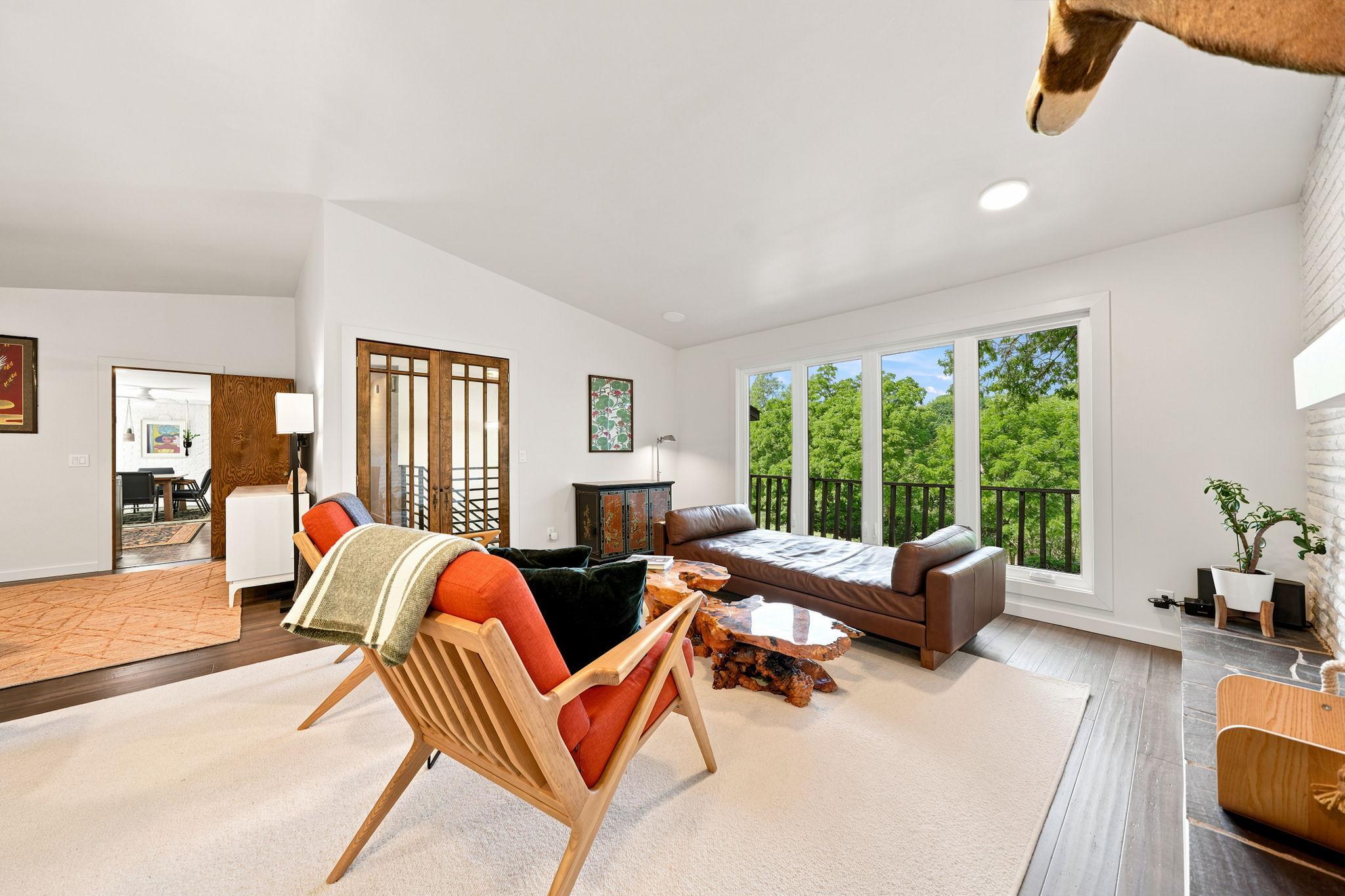 Windows on all sides of Living Room provide treehouse-like views