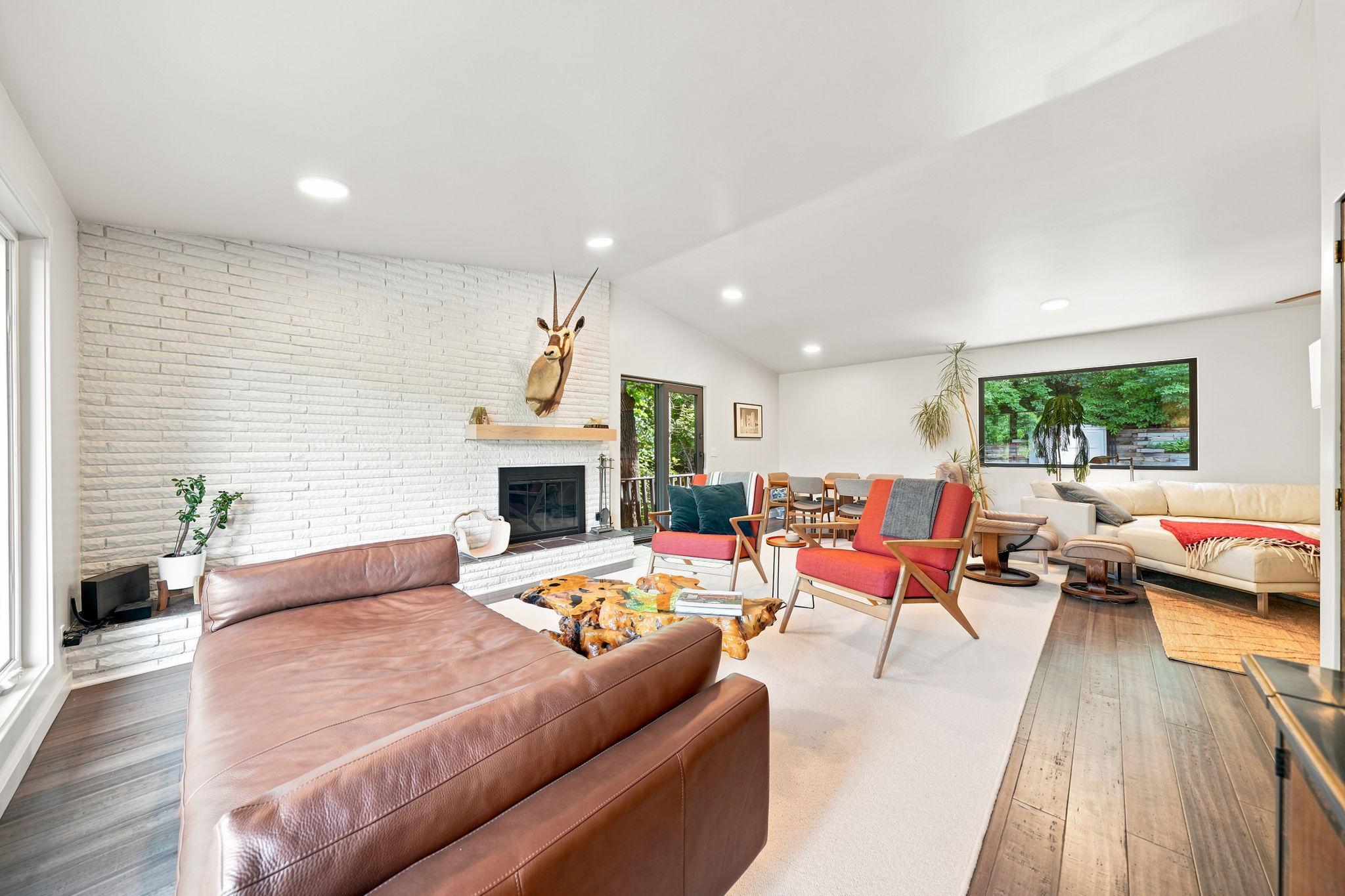 Spacious Level 1 Living Room with multiple conversation areas is perfect for entertaining