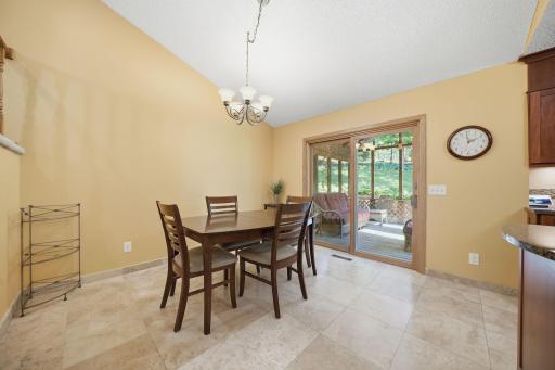 The spacious kitchen and dining area offers plenty of room to gather and opens directly to the covered porch, making it easy to enjoy meals inside or out.