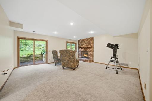 The walkout lower level is ready to be whatever you need it to be, whether that's a playroom, library, theater, home office, workout space, or simply a cozy spot to relax and enjoy a fire.