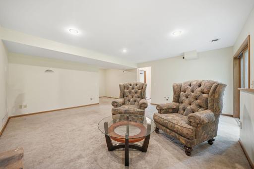 The walkout lower level is ready to be whatever you need it to be, whether that's a playroom, library, theater, home office, workout space, or simply a cozy spot to relax and enjoy a fire.
