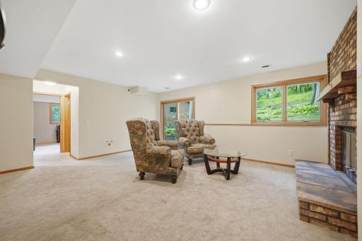 The walkout lower level is ready to be whatever you need it to be, whether that's a playroom, library, theater, home office, workout space, or simply a cozy spot to relax and enjoy a fire.