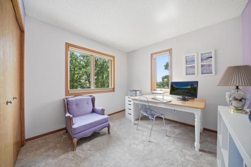 Upstairs, you'll find brand new carpet, an open and airy layout, and more beautiful windows that fill the space with natural light. This level includes two bedrooms, a full bathroom, and a spacious primary suite featuring a walk-in closet and private