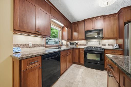 The kitchen offers plenty of cabinet space, granite countertops, and a beautiful window over the undermount sink with views of the backyard. You might even find yourself volunteering to do the dishes!