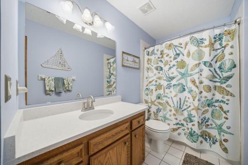 Upstairs, you'll find brand new carpet, an open and airy layout, and more beautiful windows that fill the space with natural light. This level includes two bedrooms, a full bathroom, and a spacious primary suite featuring a walk-in closet and private