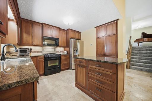 The kitchen offers plenty of cabinet space, granite countertops, and a beautiful window over the undermount sink with views of the backyard. You might even find yourself volunteering to do the dishes!