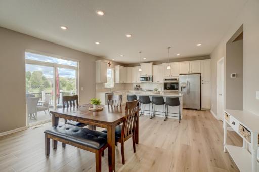 The kitchen is designed for everyday living and entertaining alike with stainless steel appliances, including a double oven, granite countertops, a spacious center island, a walk-in pantry, and abundant cabinet and counter space.