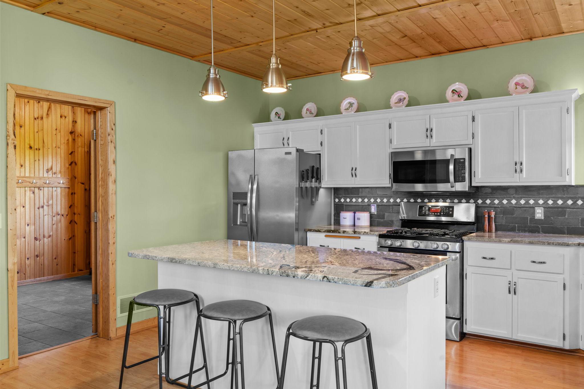 Kitchen opens to the large garage entry space