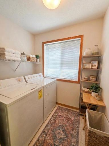 Dedicated laundry room with window, storage shelving, and convenient main-level access.