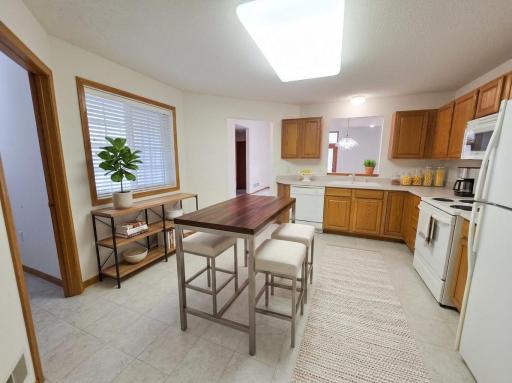 Large kitchen with ample cabinetry, generous prep space, and casual dining area.
