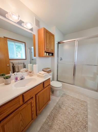 Private primary bath with large vanity, abundant storage, and walk-in shower.