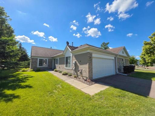 Welcome to 15714 Fjord Ave, an attractive end-unit townhome with mature landscaping and attached two-car garage.