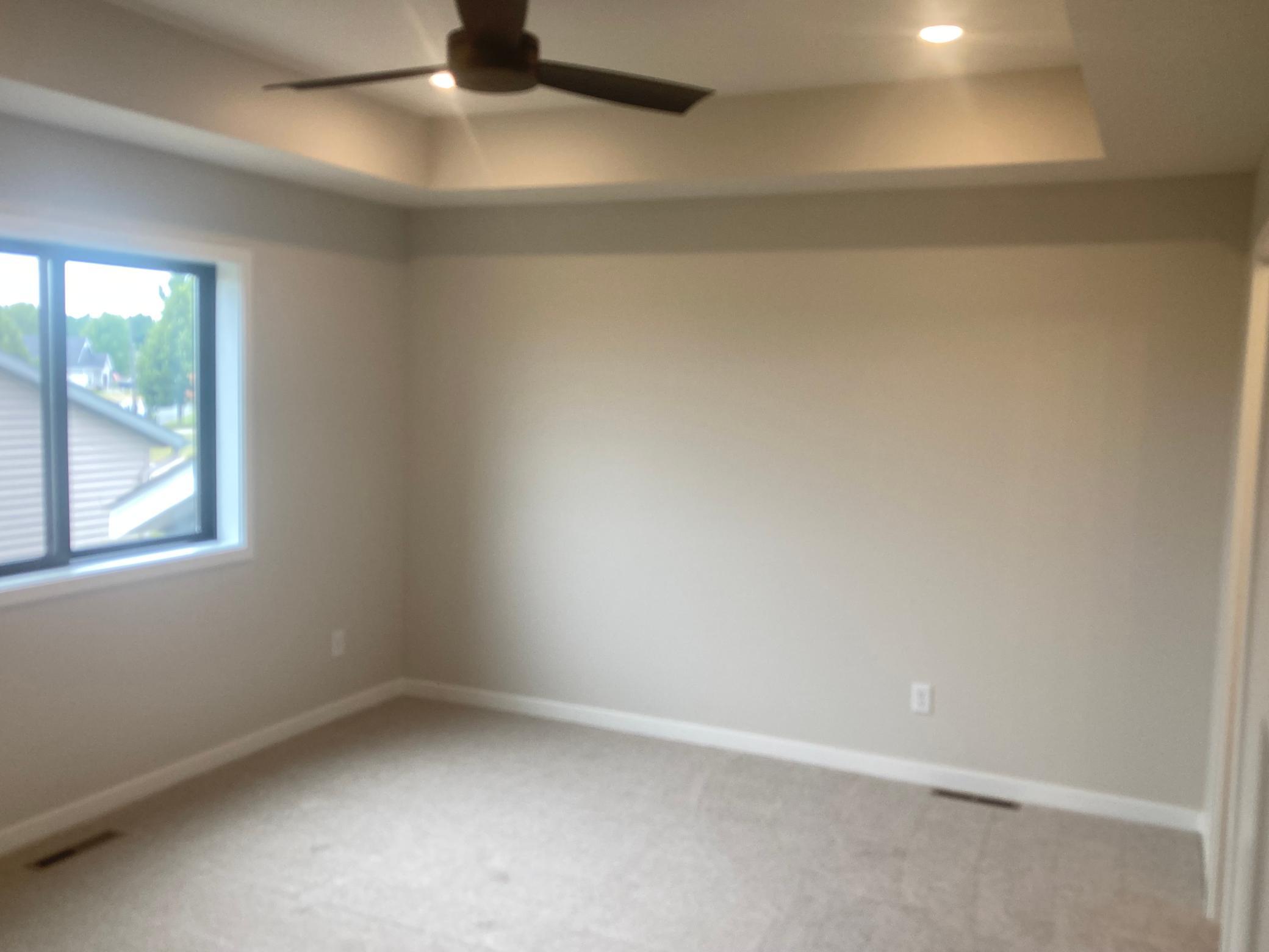 master bedroom with trey ceiling