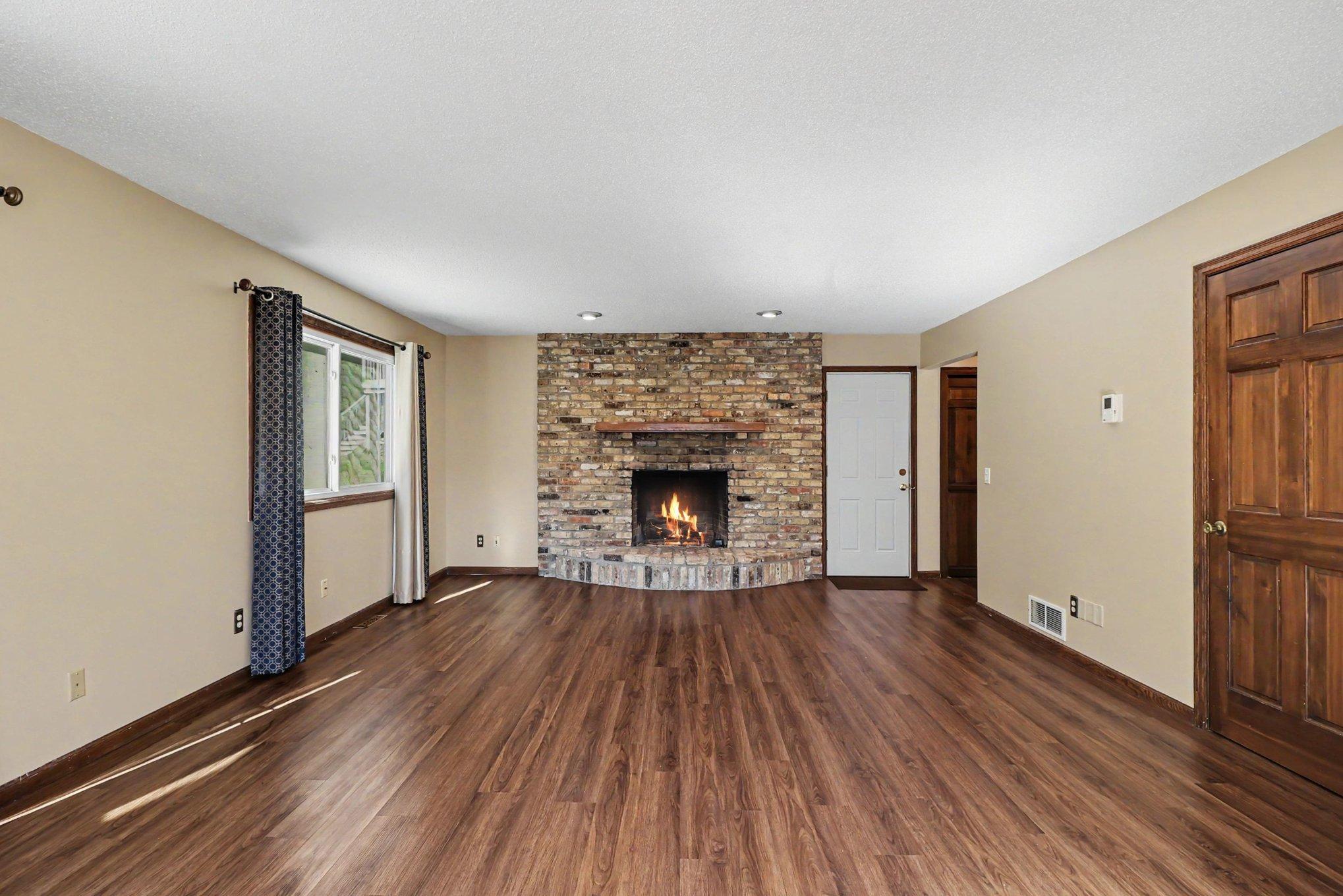 Living room is spacious and offers a gas fireplace.