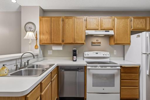 The kitchen offers an abundance of cabinet and countertop space, providing exceptional storage and functionality, and is complemented by a brand-new dishwasher.