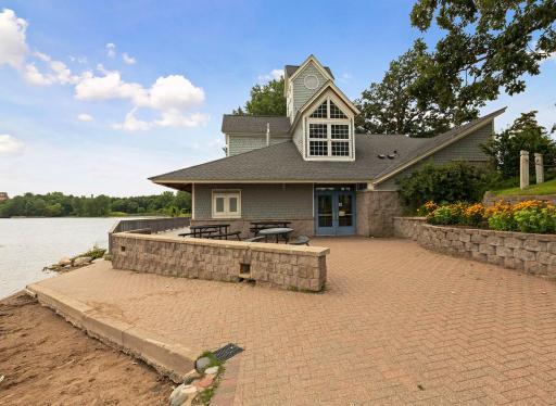 Amenities include a beach, bike rack, boat launch, drinking fountain, grills, outdoor rink, rentable park building, parking lot, picnic shelter, playground, portable restrooms, sand volleyball court, stage, and walking trails.