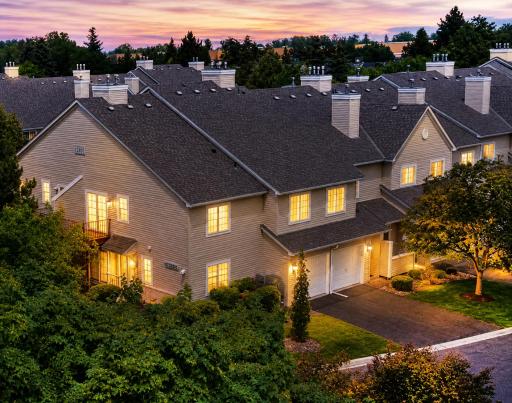 2240 Ranchview Lane N Unit#80 is amongst Pintail's most sought after upper corner units. Experience the charm of beautifully maintained townhomes with mature landscaping create an inviting sense of home. (evening photo shown is virtually enhanced).