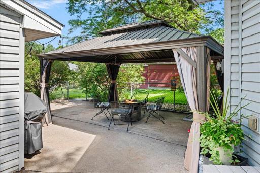 outside, the huge patio area is covered by this fantastic pergola for shade