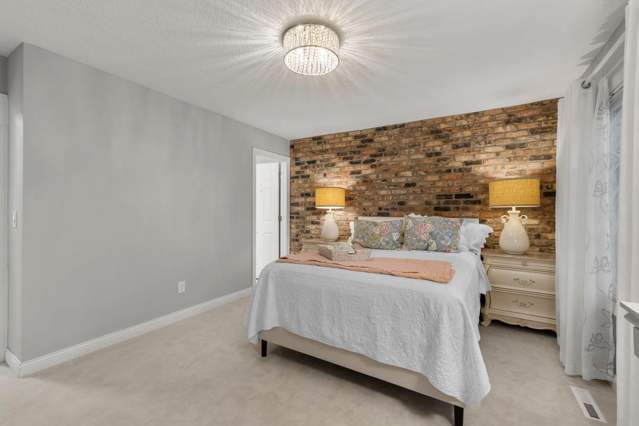 Primary Bedroom w/ Brick back wall