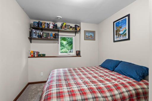 Convienntly located close by the lower level living room and bathroom, this bedroom overlooks the large side yard..jpg