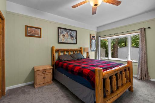 The large main level bedroom is conveniently located close to the main level living room.jpg