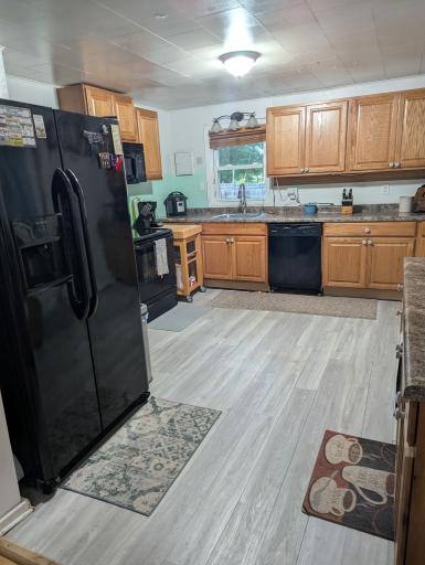 Kitchen offers newer appliances, cabinets and counter tops.