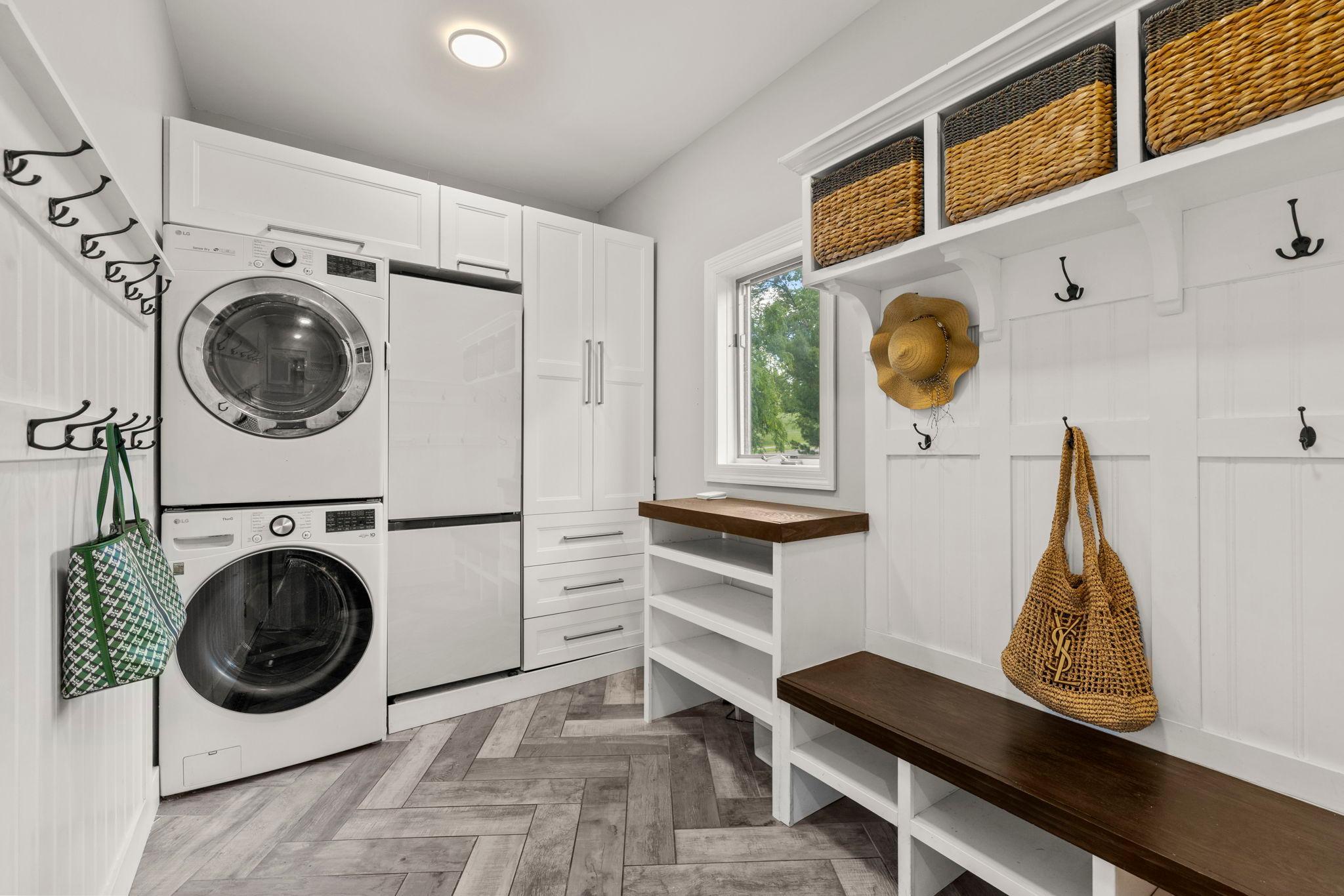 Mudroom and laundry room with an extra fridge
