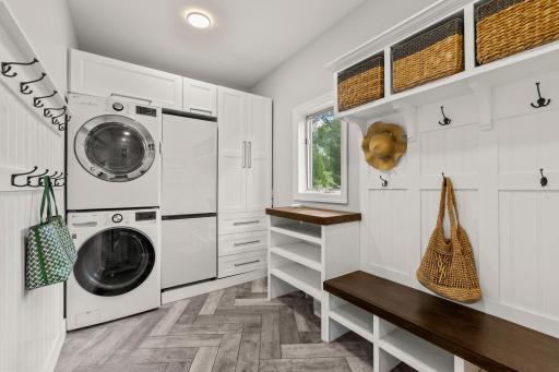 Mudroom and laundry room with an extra fridge