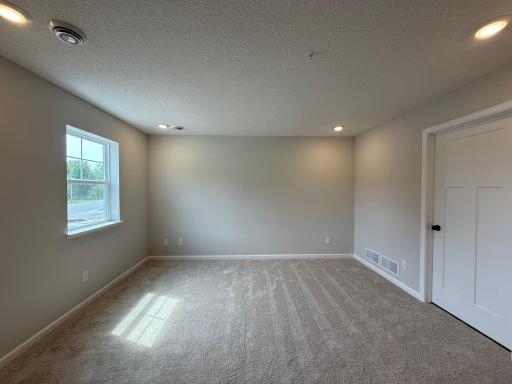 At the entry of the home, we have a spacious rec. space that is great, as a secondary living area, office, or even a makeshift 4th bedroom when you need added space!