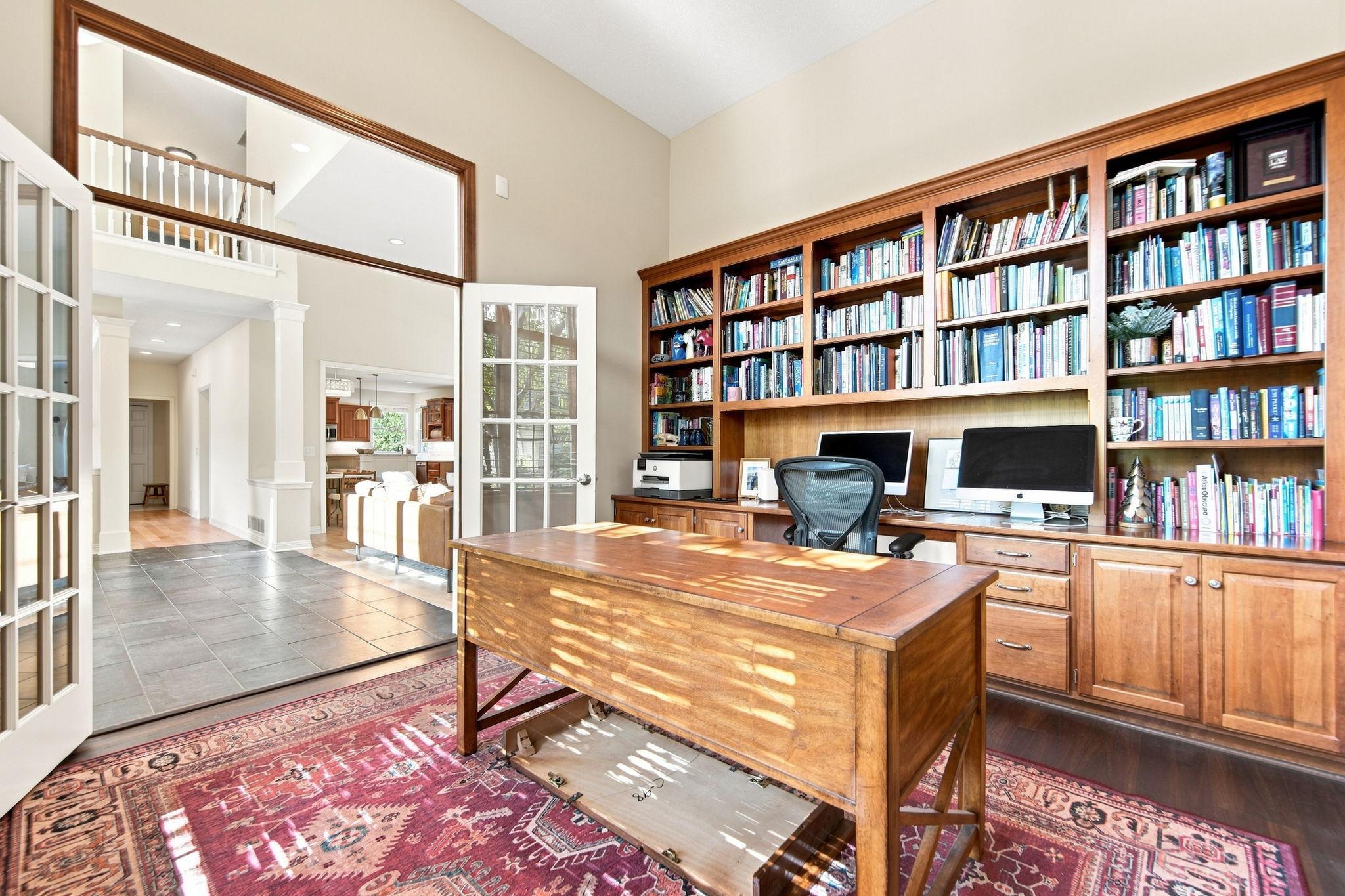 Two large windows and transome window above the double doors make this room cheerful