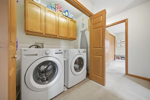 Washer and Dryer on the main level, neatly tucked away behind closet doors