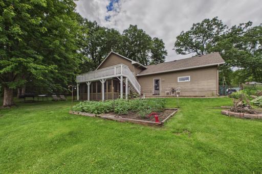 Fully fenced back yard living area with established gardens