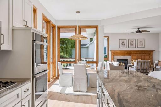 Kitchen open to informal dining area. Full view windows fill the space with natural light.