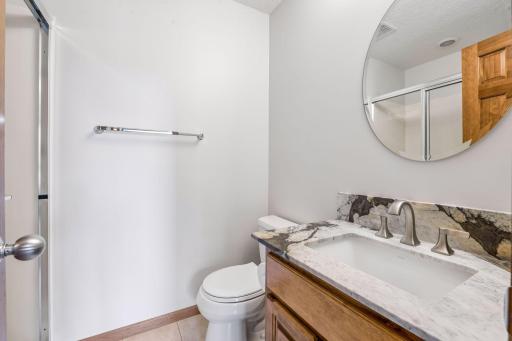 Private bath with new quartzite vanity tops, New lighting and fixtures.