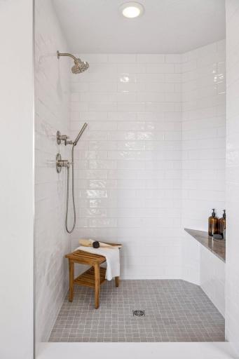 New tiled shower surround, shower pan and quartzite bench seat. New dual shower fixtures.