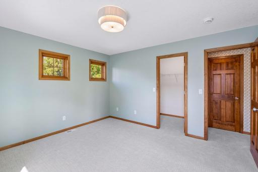 Bedroom #3 of 4 on upper level with new carpet, lighting and walk-in closet.