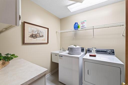An organized space for laundry featuring Speed Queen washer and dryer!