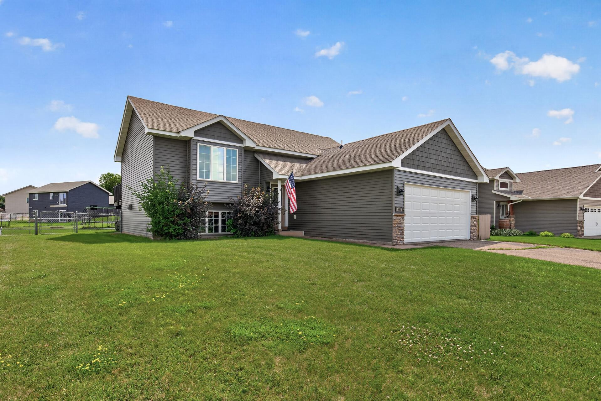 Home with the extras: Brand New Carpet, Paint, Vinyl Siding and Garage Door! Plus a newer furnace! Appliances and window treatments are included! Better than new construction!