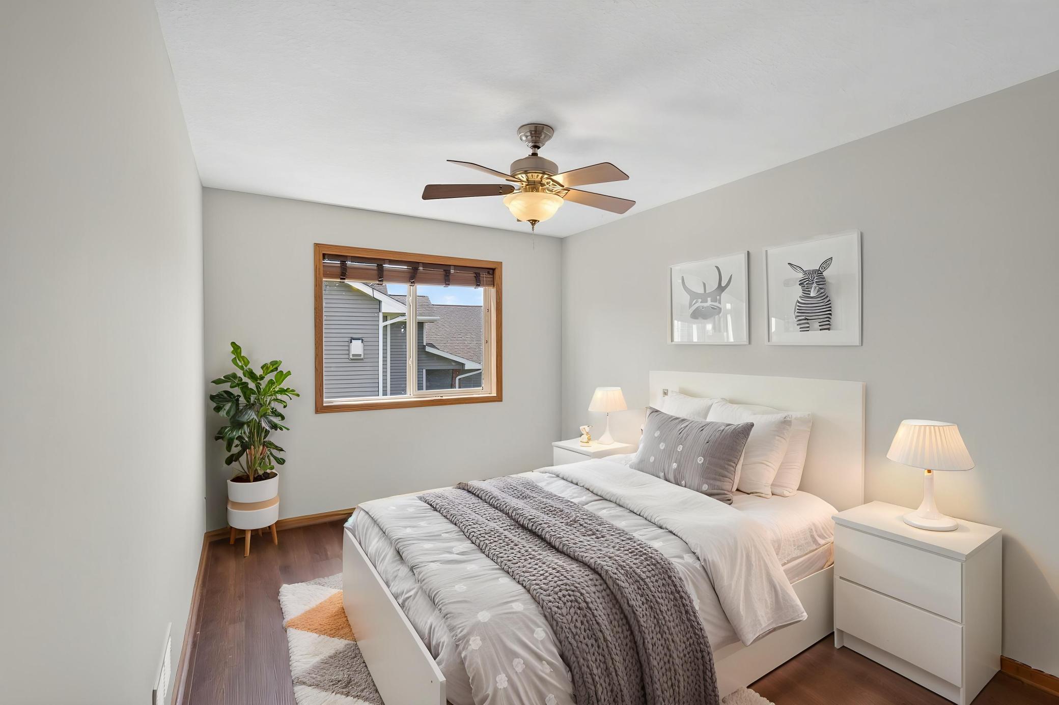 Spacious Upper level bedroom with laminate flooring and ceiling fan!