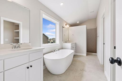 Elegantly tiled walk-in shower in ownerâs bathroom.