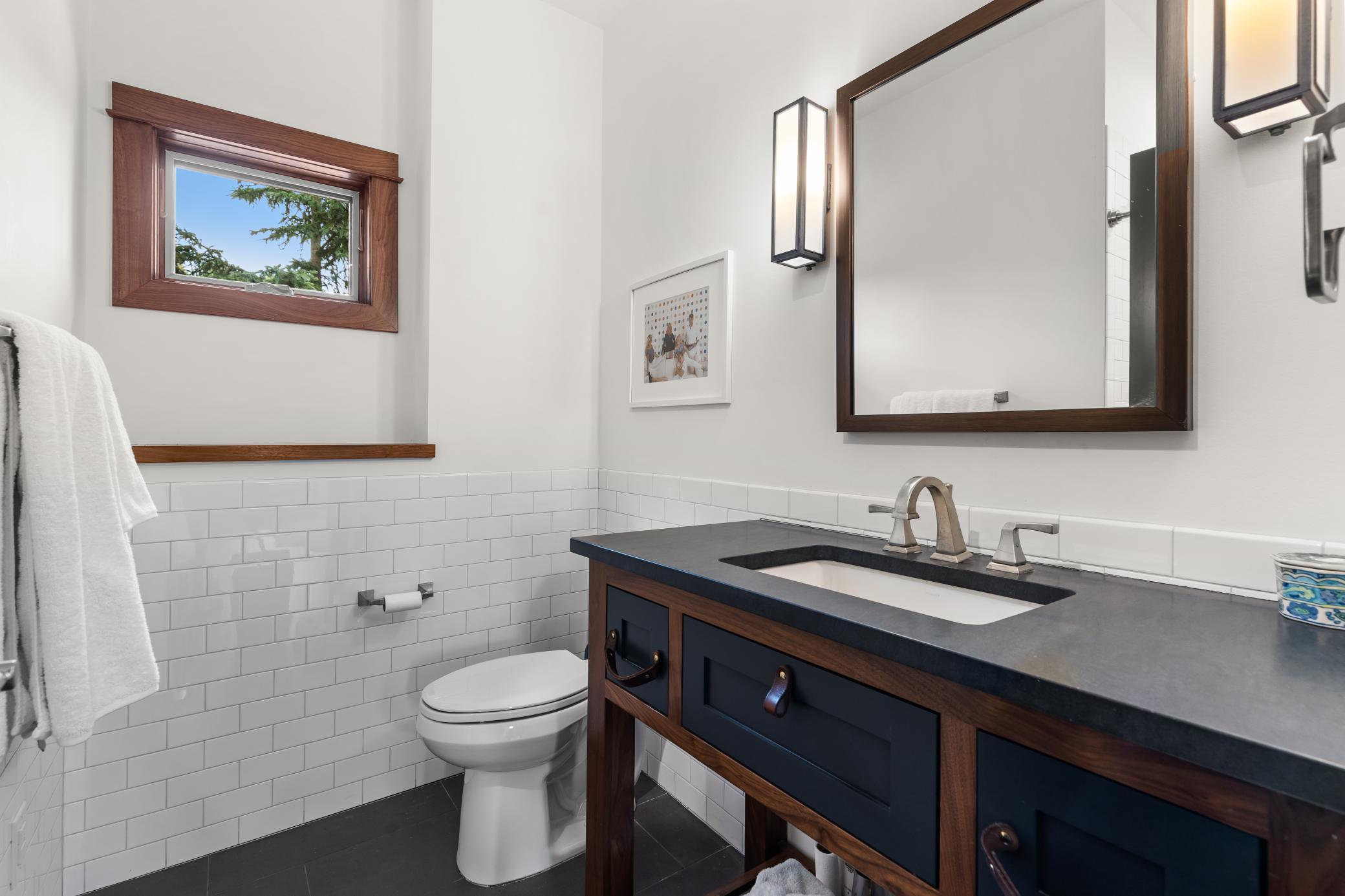 Guest house bathroom is freshly tiled and filled with light