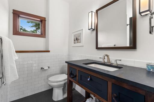Guest house bathroom is freshly tiled and filled with light