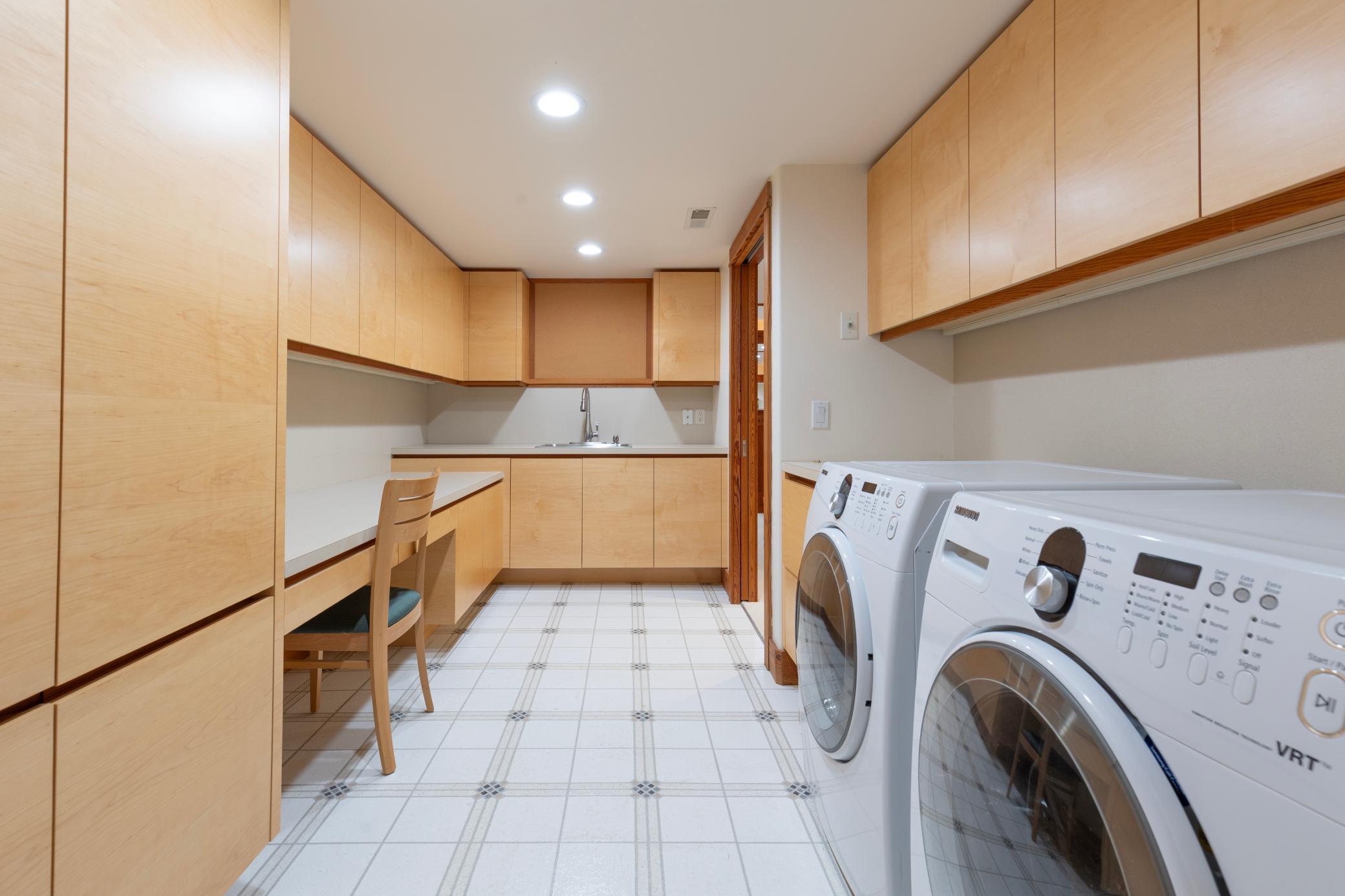 Lower level laundry and storage cabinets for seasonal over flow and functionality