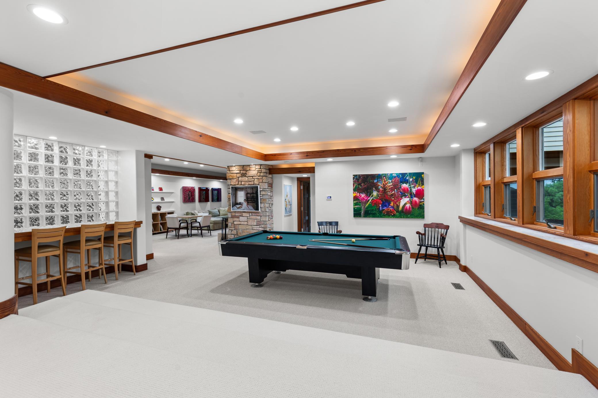 Study area and billiards room are flanked by glass block and natural light