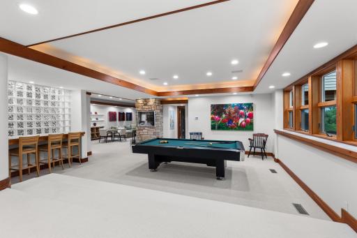 Study area and billiards room are flanked by glass block and natural light