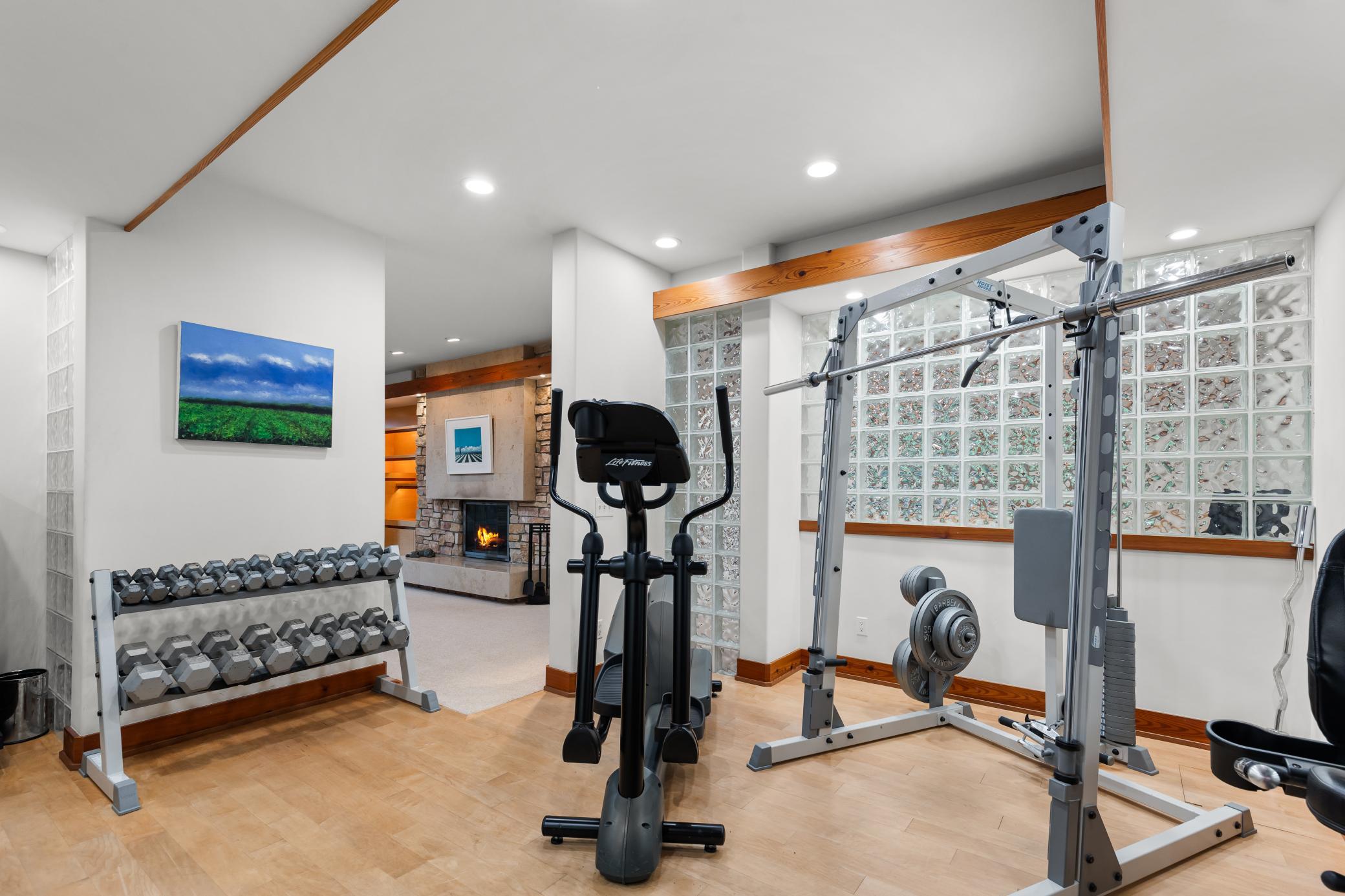 A gym with glass block - surround lighting and signature detailing
